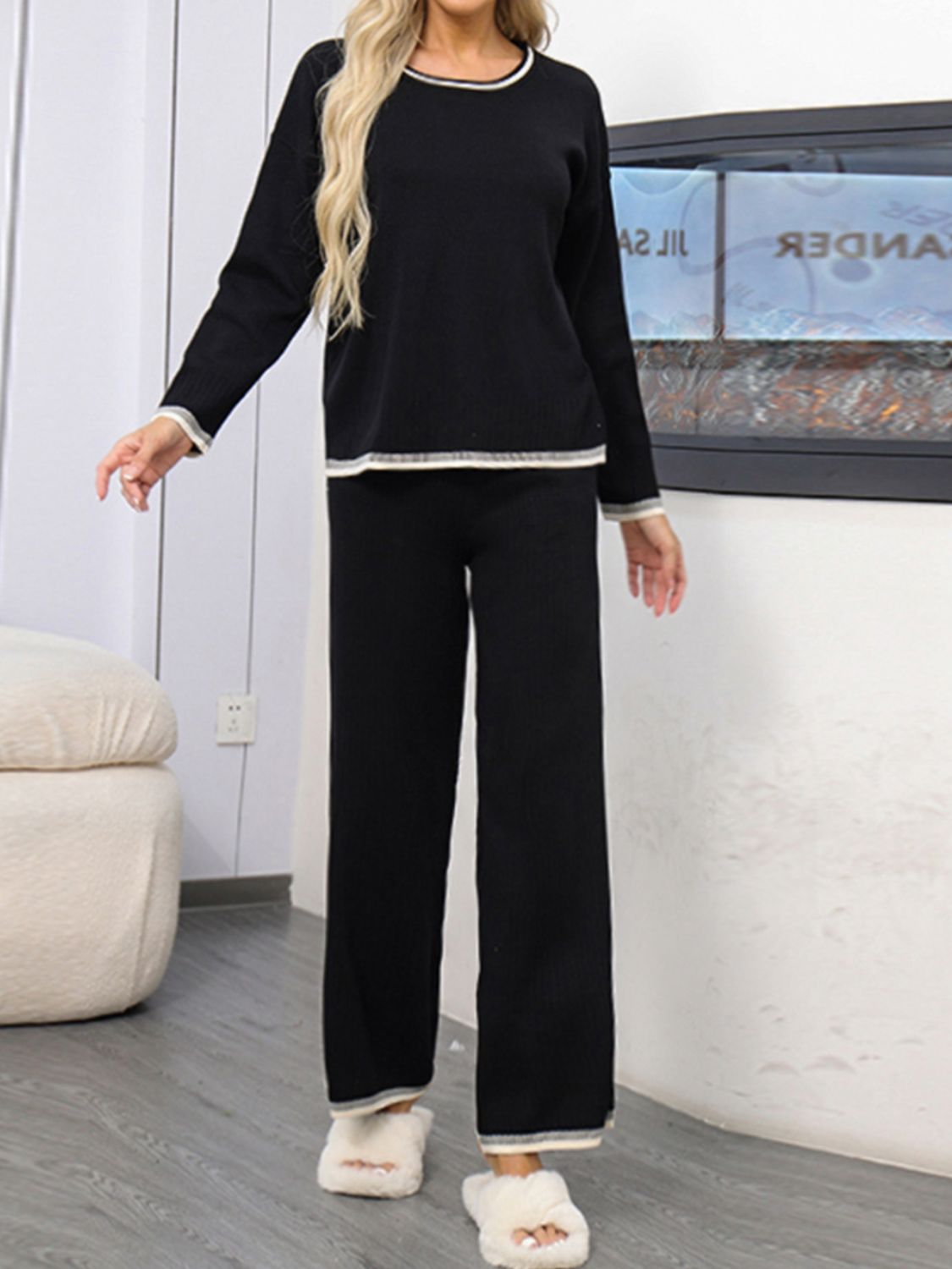 Black acrylic sweater set with contrast trim on neckline, cuffs, and hem.