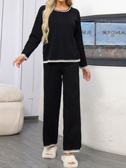 Black acrylic sweater set with contrast trim on neckline, cuffs, and hem.