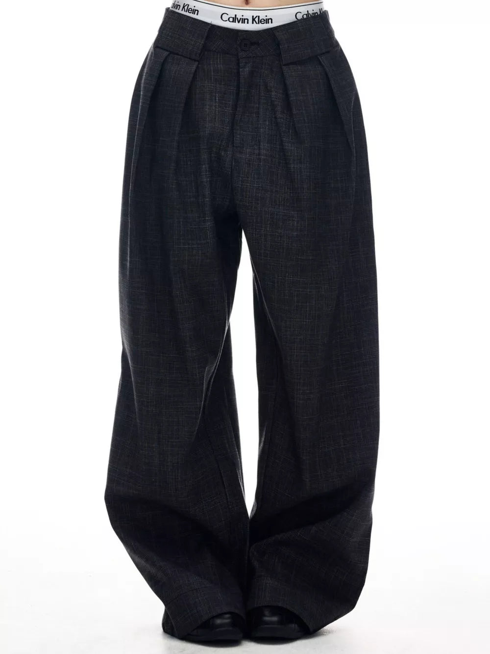 Men's dark grey wide-leg trousers with pleats and a textured weave.