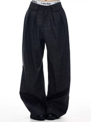 Men's dark grey wide-leg trousers with pleats and a textured weave.