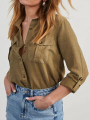 Olive brown washed denim utility shirt with buttoned chest pockets and rolled sleeves.