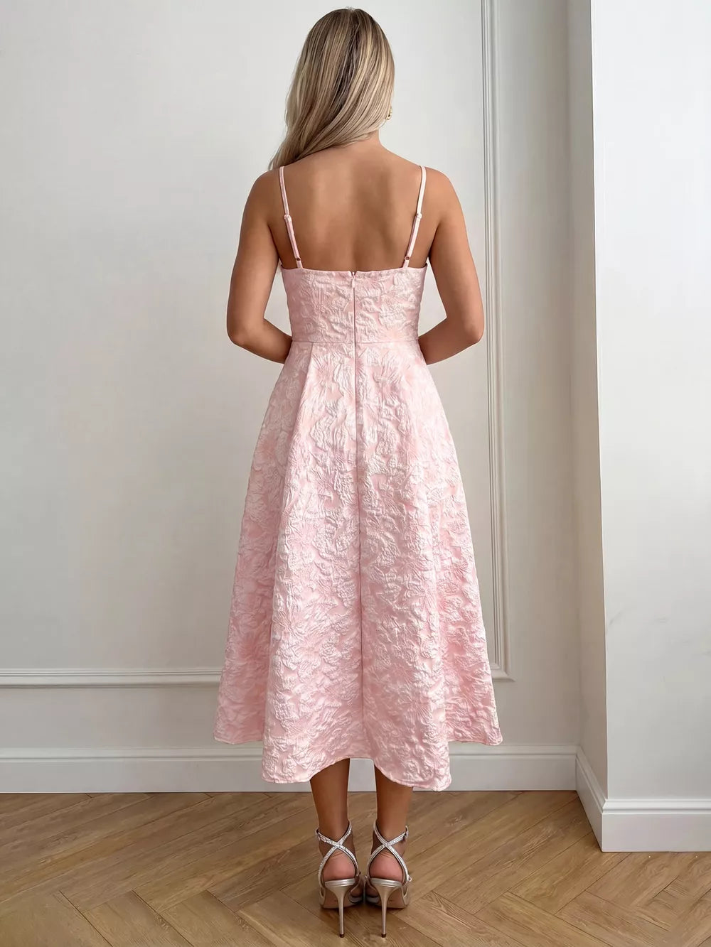 Blush pink textured floral a-line midi gown with spaghetti straps and a full skirt.