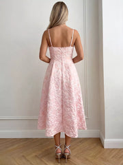Blush pink textured floral a-line midi gown with spaghetti straps and a full skirt.