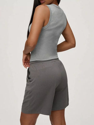 Light gray ribbed button-front fitted tank top with a high neckline.