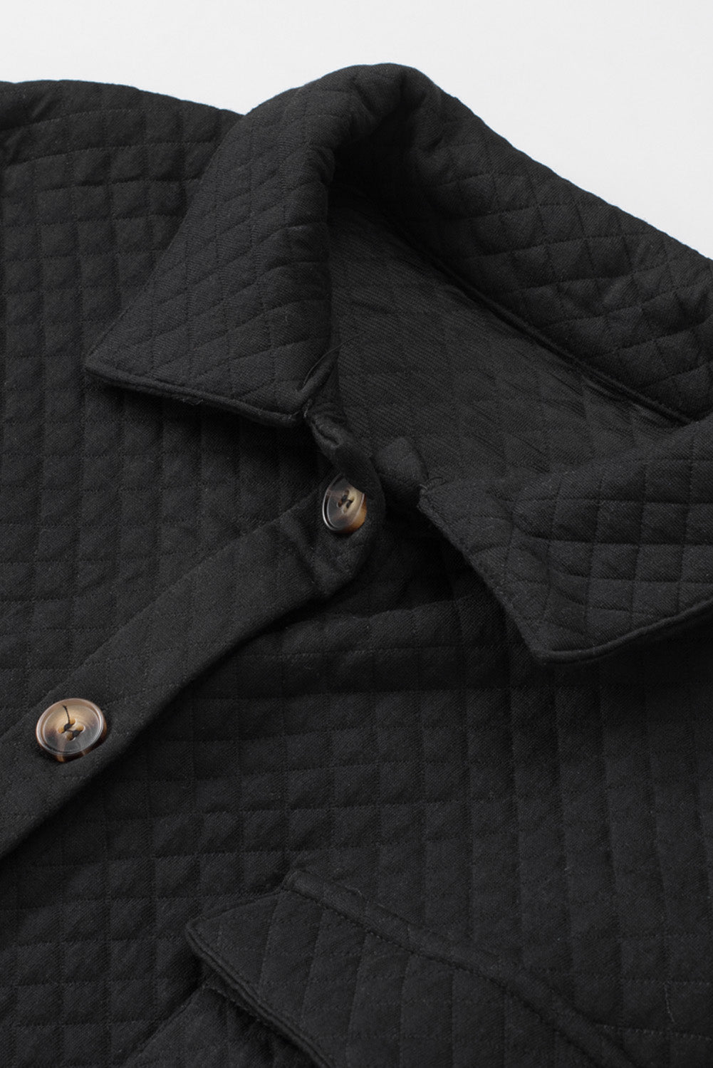 Black quilted overshirt with button details and patch pocket flap.