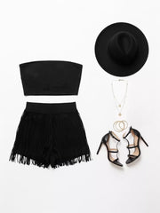 Black fringe shorts and bandeau top two-piece set with strappy heels and hat.