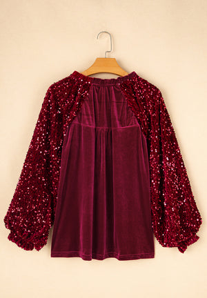 Red velvet blouse with sequin balloon sleeves and gathered neckline.