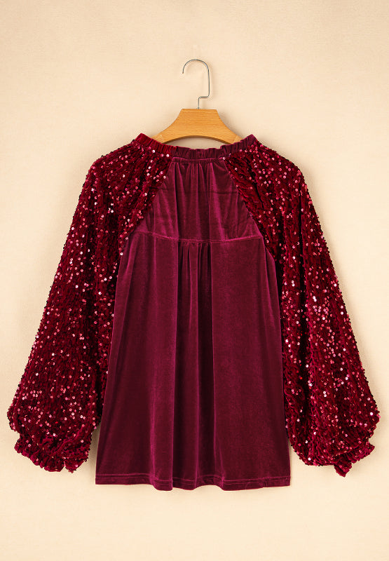 Red velvet blouse with sequin balloon sleeves and gathered neckline.