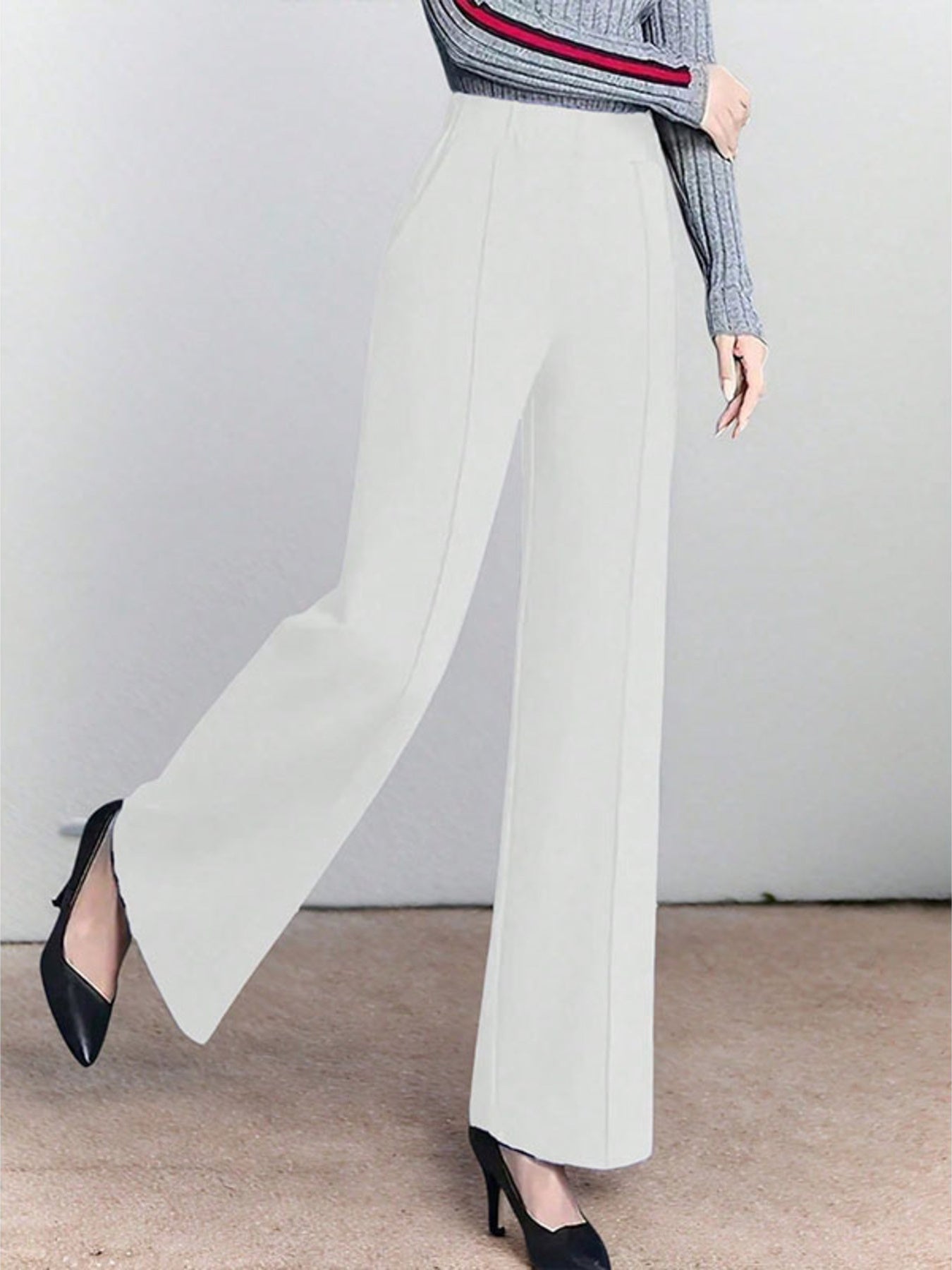 White high-waisted wide leg cotton trousers with pockets and front seams.
