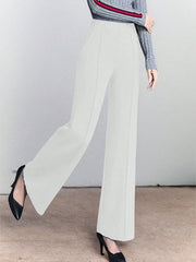 White high-waisted wide leg cotton trousers with pockets and front seams.