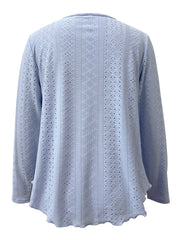Light blue eyelet blouse with scalloped hem and long sleeves.