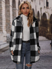 Checked plaid teddy coat with oversized collar in black and white, featuring a fuzzy texture and open front.