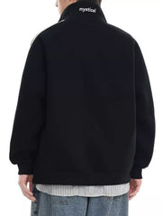 Black zip-up sweatshirt with white stripe detail on shoulder and "mystical" text on collar.
