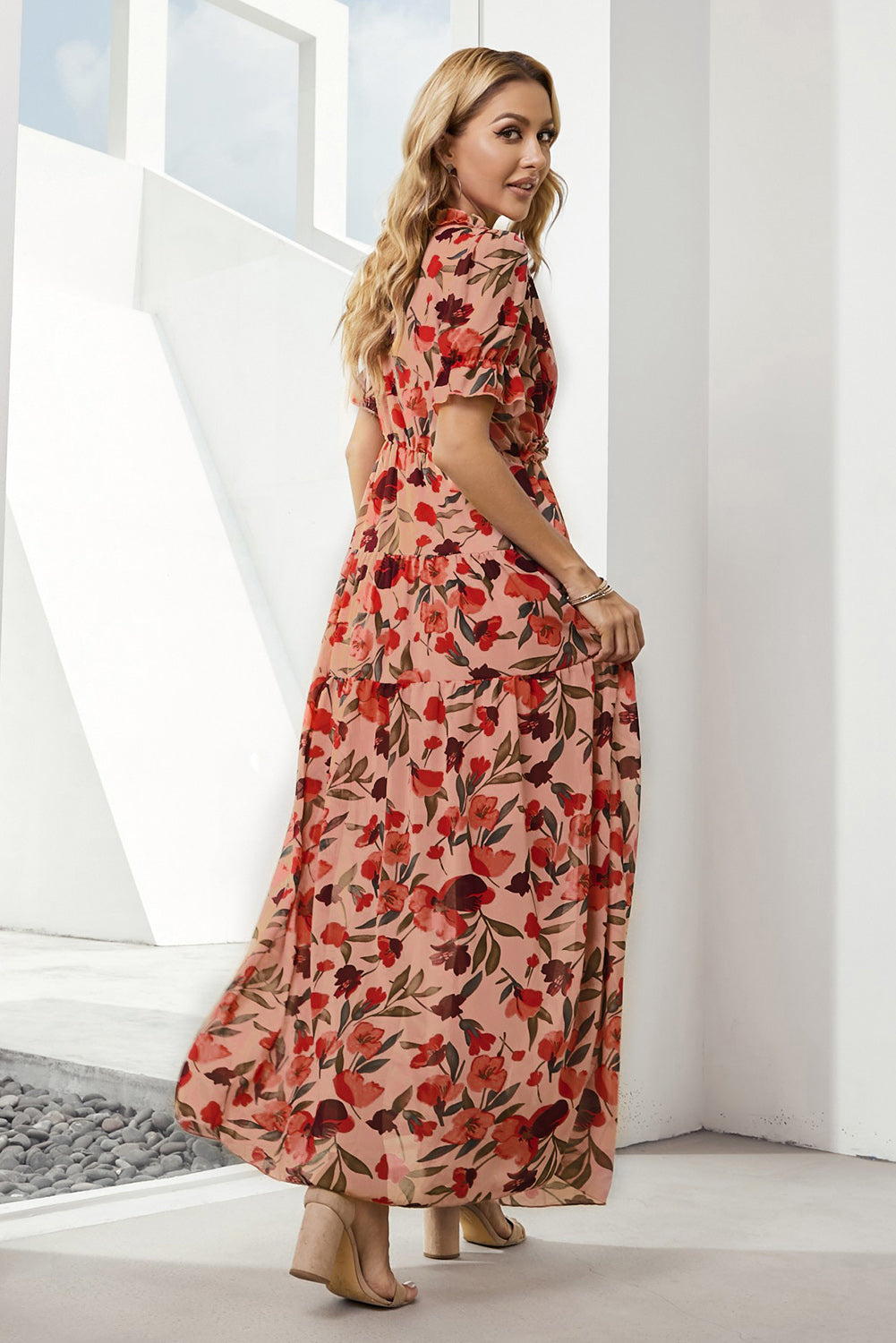 Tiered floral maxi dress in blush with puff sleeves and a flowing skirt.
