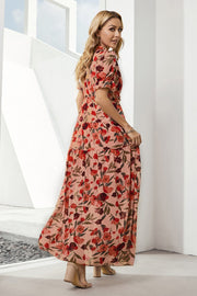 Tiered floral maxi dress in blush with puff sleeves and a flowing skirt.
