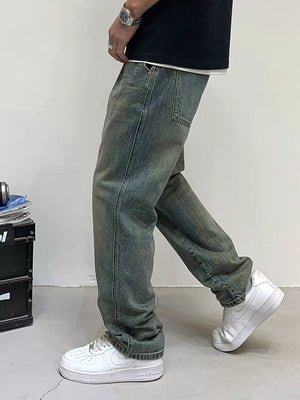 Men's loose-fit jeans in blue-green wash with distressed details.