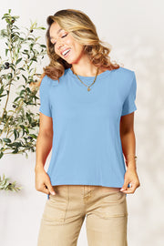 Slit hemline crew neck tee in light blue, made from bamboo fabric, styled with gold jewelry.