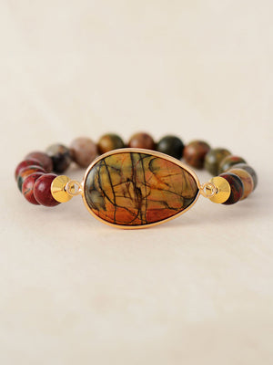 Prismatic bead and stone bracelet with a teardrop-shaped agate centerpiece and gold accents.