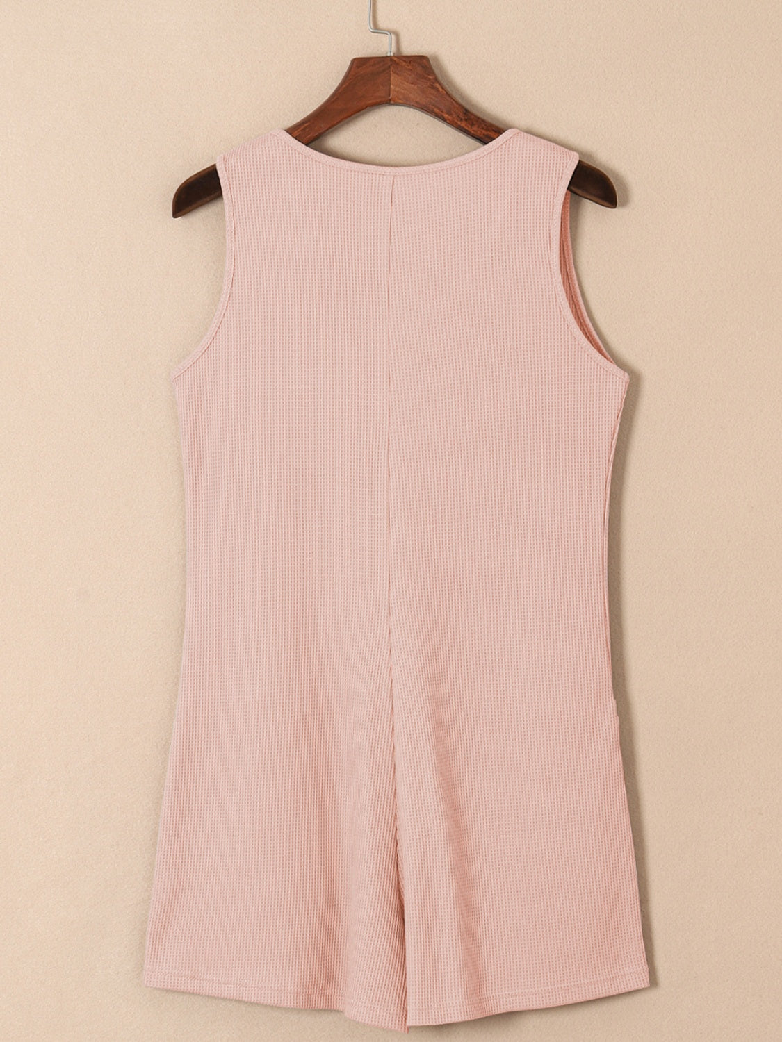 Blush pink waffle knit button-down romper with pockets, sleeveless, round neck