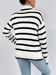 Oversized black and white striped turtleneck sweater with ribbed cuffs and hem.