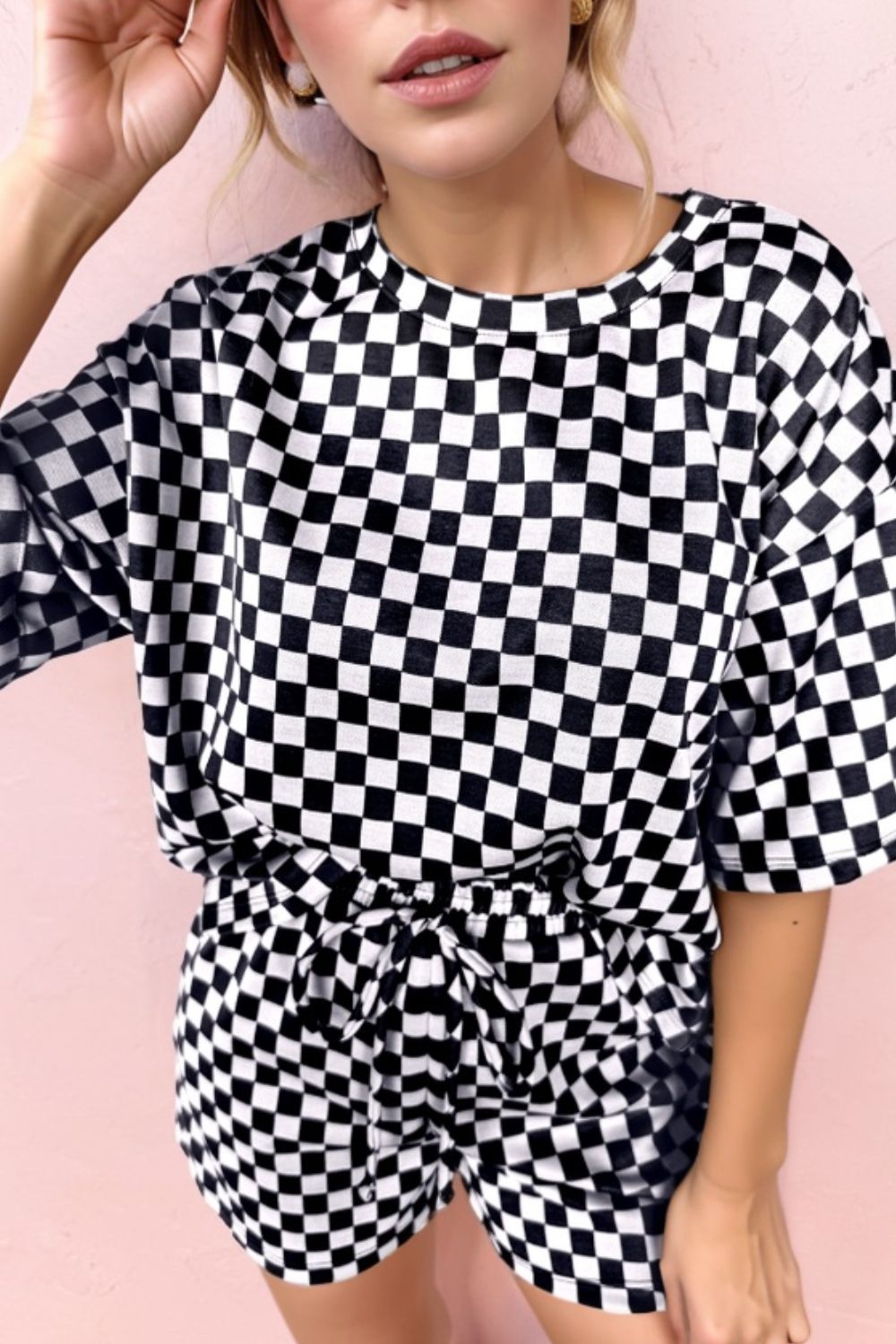 Black and white checkered loungewear set with drawstring shorts and a short-sleeve top.