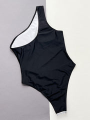 Black one-shoulder swimsuit with white lining and sequin panel detail.