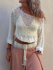 Beige asymmetric crochet crop top with open knit and 3/4 sleeves.