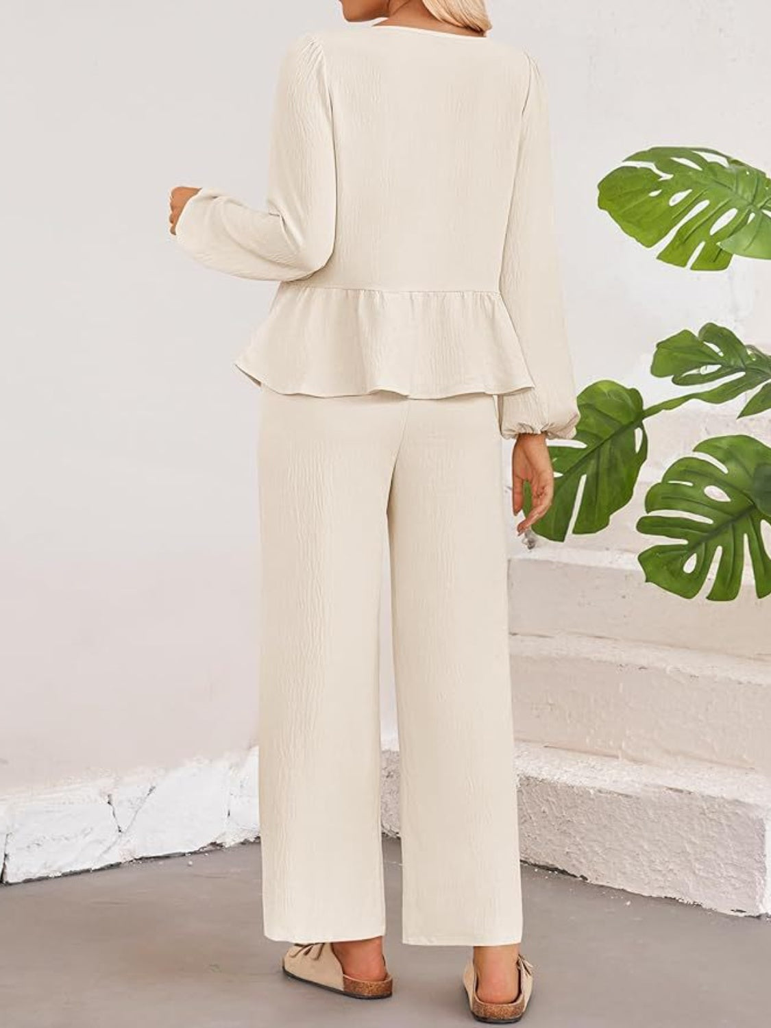 Cream textured peplum tie-neck co-ord set with wide leg pants and balloon sleeves.