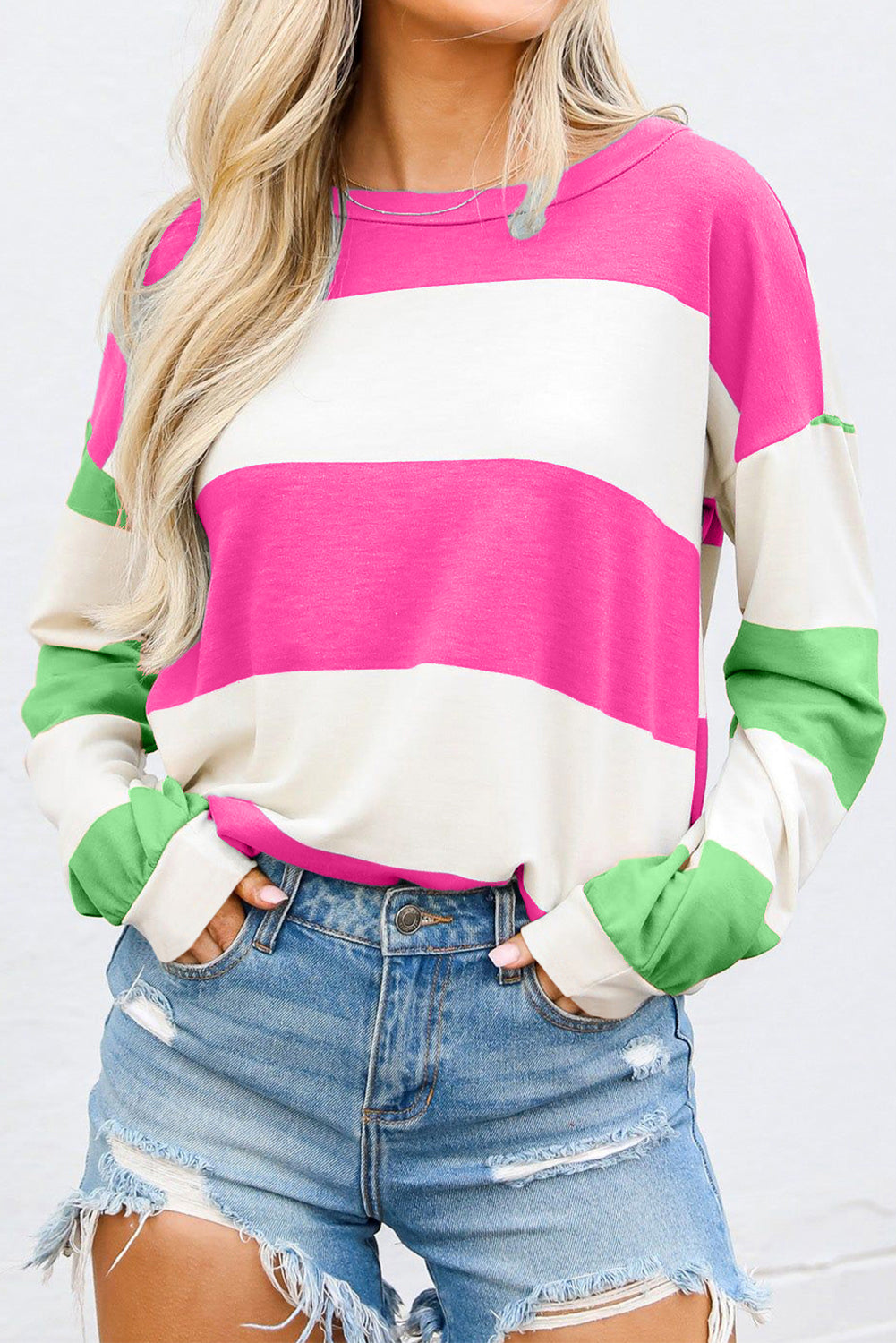Striped sweatshirt in pink, white, and green with block sleeves and a crew neck.