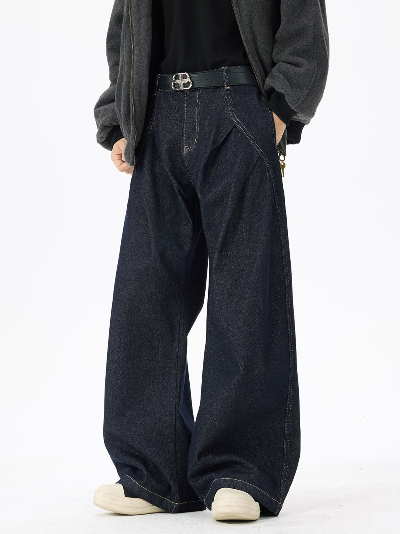 Dark wash denim jeans with exaggerated wide legs and contrast stitching.
