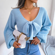 Sky blue ribbed knit crop cardigan with bow front and balloon sleeves.