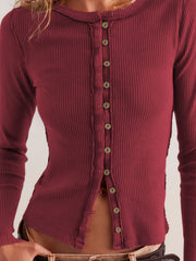 Ribbed button-up top in Rust with a round neckline and long sleeves.
