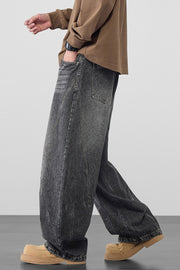 Men's dark gray 100% cotton oversized wide-leg jeans with a washed look.