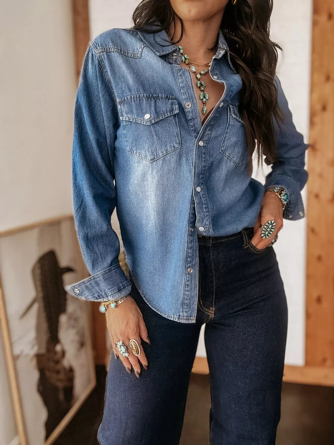 Classic blue denim button-down shirt with two chest pockets and button cuffs.