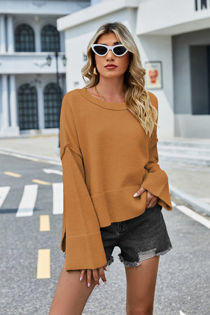 Ochre acrylic knit sweater with flared sleeves and split hem detail.