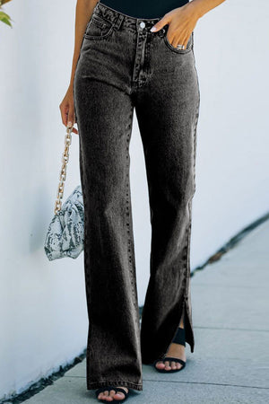 Dark wash denim trousers with flared hem and side slits.