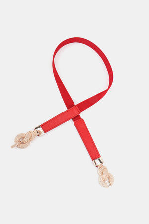 Red elasticated waist belt with gold knot detail and faux leather ends