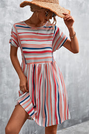 Striped trapeze dress with short sleeves and a yoke seam in coral, navy, and grey stripes.