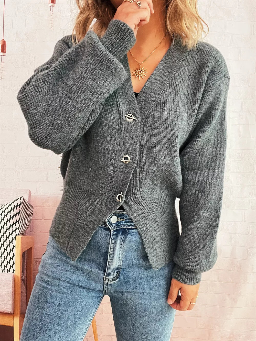 Gray ribbed V-neck button-through cardigan with balloon sleeves and silver hardware.
