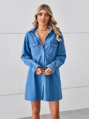 Denim shirt dress in dusty blue with button front, chest pockets, and elastic cuffs.