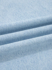 Light wash denim fabric detail, showing texture and weave of wide-leg jeans.