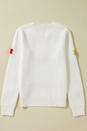 White knit sweater with crochet floral embellishments on sleeves, crew neck, long sleeves.
