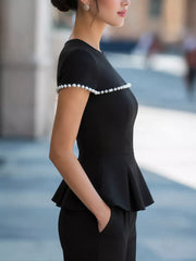 Black peplum t-shirt with pearl trim on sleeves and neckline.