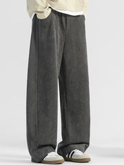 Men's dark gray loose fit sweatpants with pockets and a textured fabric.