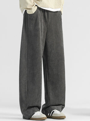 Men's dark gray loose fit sweatpants with pockets and a textured fabric.