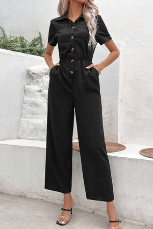 Black lace yoke button-down wide leg jumpsuit with short sleeves and a collared neckline.