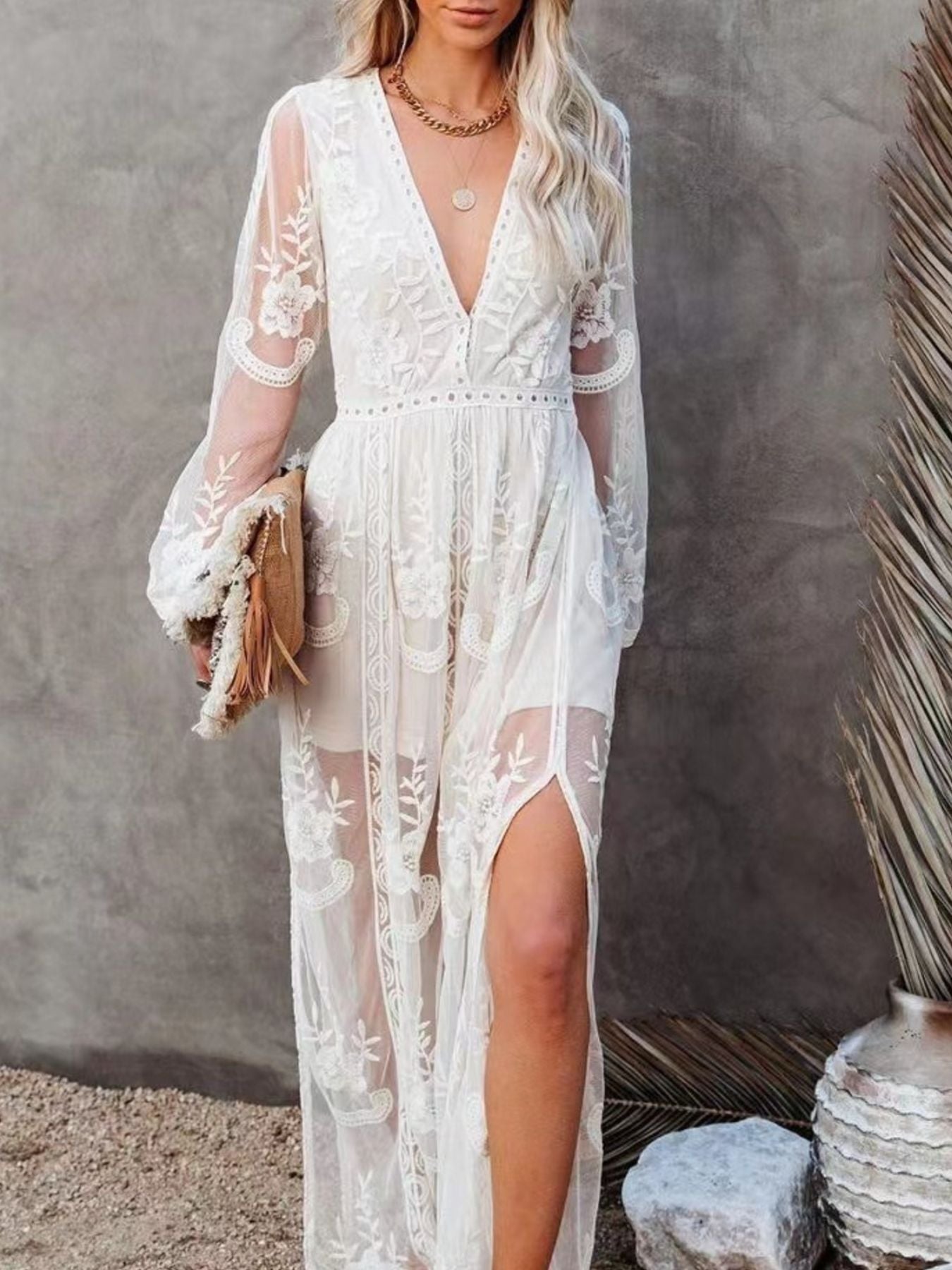 White floral lace maxi dress with V-neck, long sleeves, and high slit.