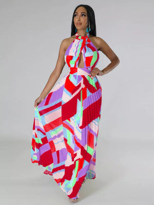 Halter neck maxi dress with geometric print, cut-out detail, and pleated skirt.