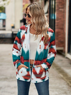 Aztec print zip-up hooded jacket with white, teal, rust, and brown geometric pattern.