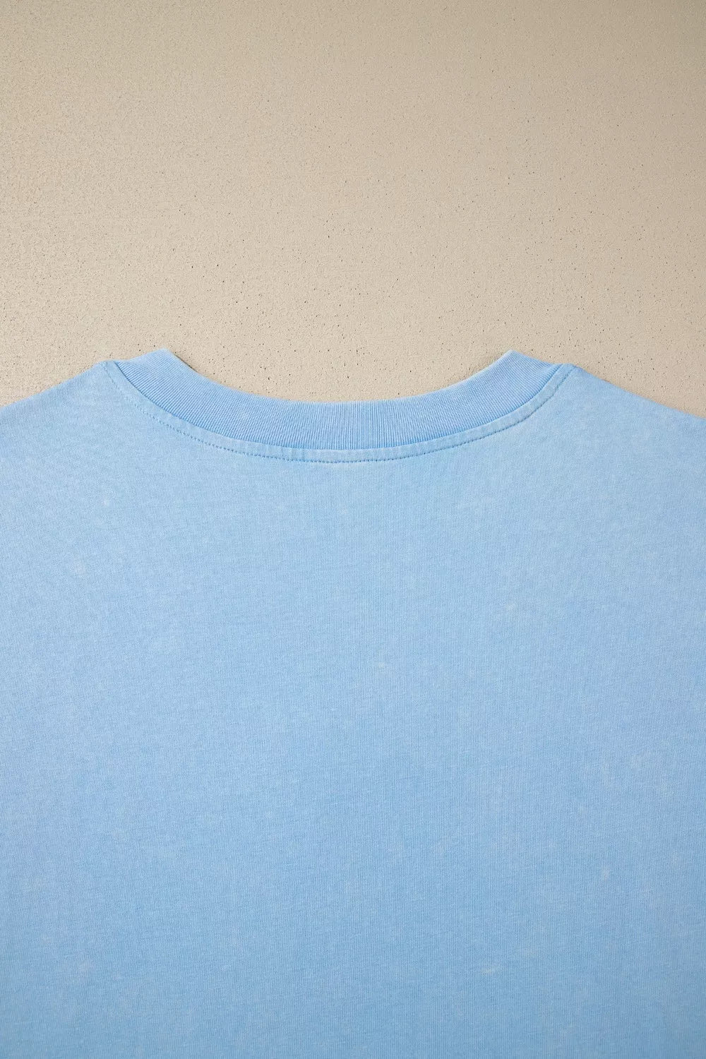 Light blue cotton relaxed V-neck top with ribbed neckline